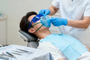 Male patient receiving sedation before a dental implant procedure at Lethbridge Dental Services South in Lethbridge, Alberta